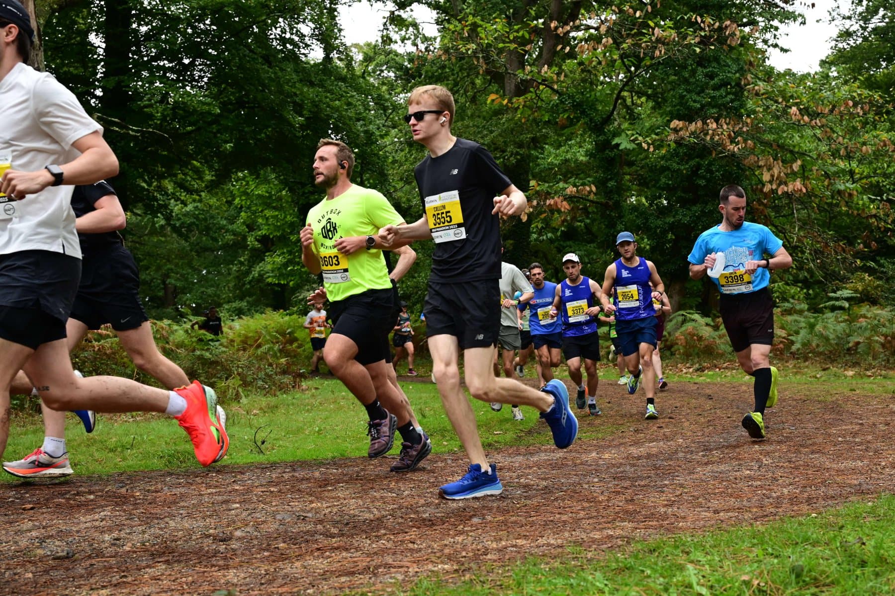 Enhance-d club runners in team kit on a New Forest trail
